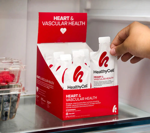 Hand picking up a 'HealthyCell' product from a display with heart and vascular health label.